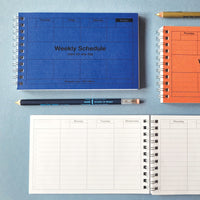 Three weekly schedule planners in blue, orange, and white on a gray background.
